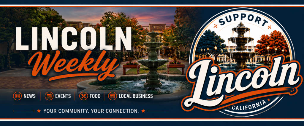 A charming town square at dusk with a tiered fountain, trees lit with string lights, and buildings.